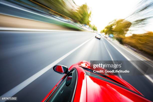driving on the highway - red car stock pictures, royalty-free photos & images