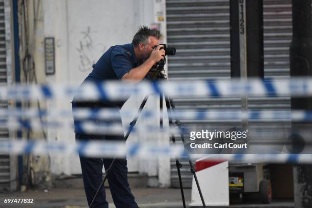 Police forensics officer works in a road near an incident near Finsbury Park Mosque in which a van ploughed into pedestrians, is pictured on June 19,...