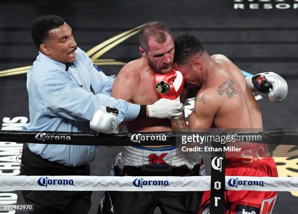 Referee Tony Weeks separates Sergey Kovalev and Andre Ward in the seventh round of their light heavyweight championship bout at the Mandalay Bay...