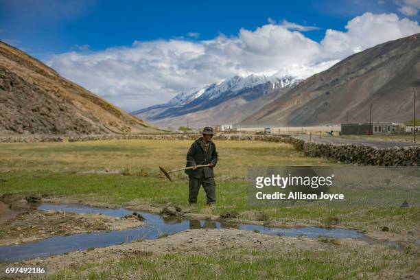 Man tends his field in Lukung village, which is reliant on solar energy, on June 13, 2017 in Ladakh, India. The cold desert of Ladakh has been known...