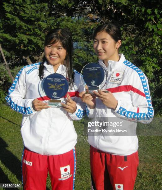 Japanese swimmers Suzuka Hasegawa and Rikako Ikee pose for photos with their trophies in Canet-en-Roussillon, France, on June 18 after 17-year-old...