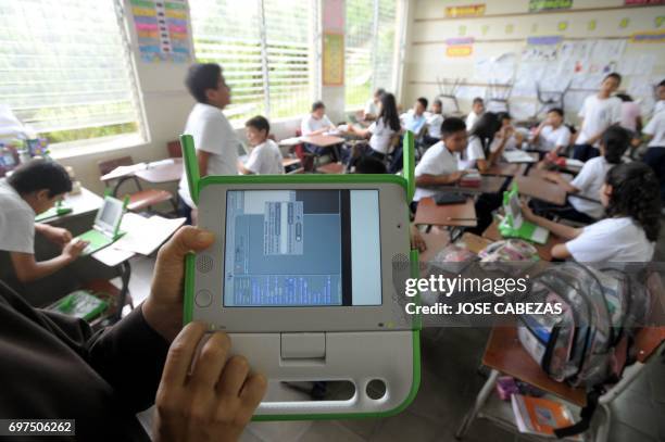 Mother Carmen Maria Parada shows a OLPC XO laptop at the Nuestra Senora del Rosario Catholic School in San Marcos, 5 km south from San Salvador, El...
