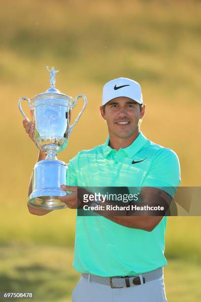 Brooks Koepka of the United States poses with the winner's trophy after his victory at the 2017 U.S. Open at Erin Hills on June 18, 2017 in Hartford,...