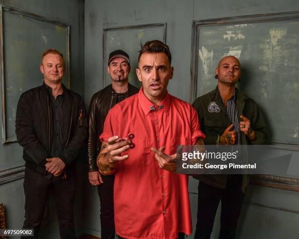 Jay Beni, Tommy Mac, Jacob Hoggard and Dave Rosin of Hedley pose for a portrait at the 2017 iHeartRADIO MuchMusic Video Awards at MuchMusic HQ on...
