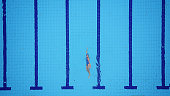 Drone point of view on swimming pool and female backstroke swimmer