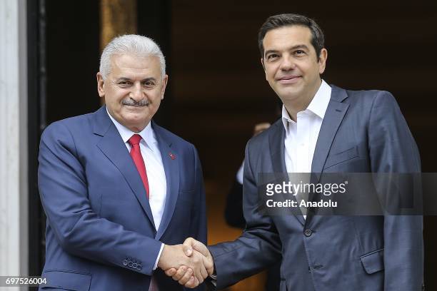 Prime Minister of Turkey Binali Yildirim shakes hands with Prime Minister of Greece Alexis Tsipras ahead of their meeting, in Athens, Greece on June...