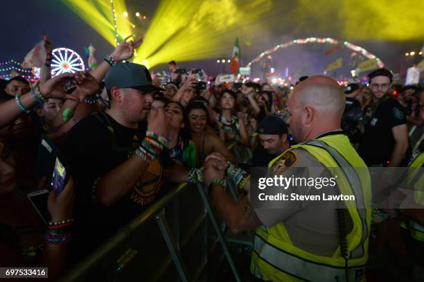 Fans react during a performance by DJ/producer Marshmello during the 21st annual Electric Daisy Carnival at Las Vegas Motor Speedway on June 18, 2017...