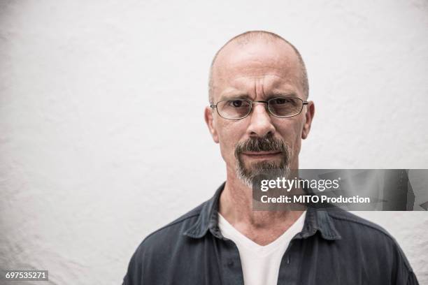 portrait of a suspicious mature man, munich, bavaria, germany - goatee stock pictures, royalty-free photos & images