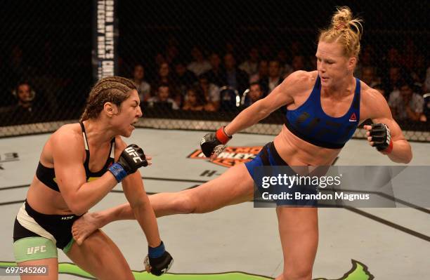 Holly Holm kicks Bethe Correia of Brazil in their women's bantamweight bout during the UFC Fight Night event at the Singapore Indoor Stadium on June...