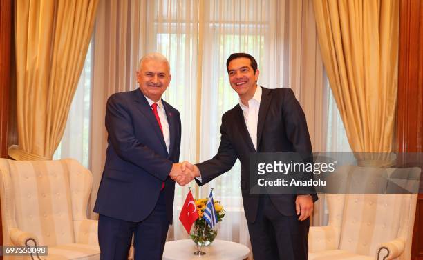 Prime Minister of Turkey Binali Yildirim shakes hands with Prime Minister of Greece Alexis Tsipras ahead of their meeting, in Athens, Greece on June...