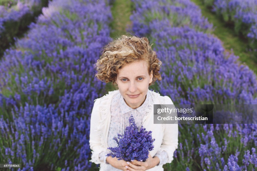 Portrait Of Woman Holding Purple Flowers