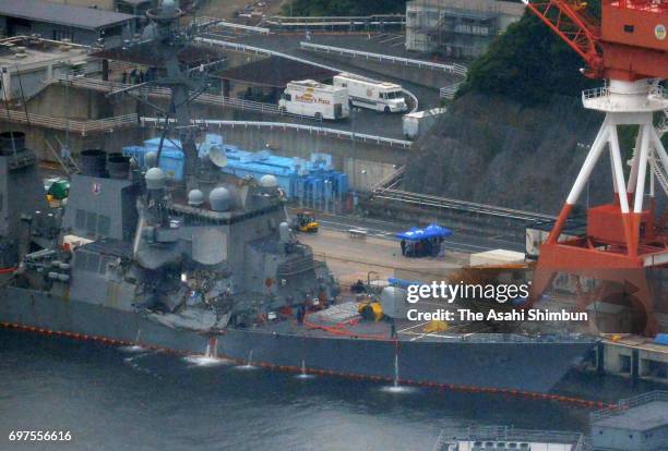 In this aerial image, the USS Fitzgerald, which suffered severe damage on the starboard side, is anchored at the U.S. Naval base on June 18, 2017 in...