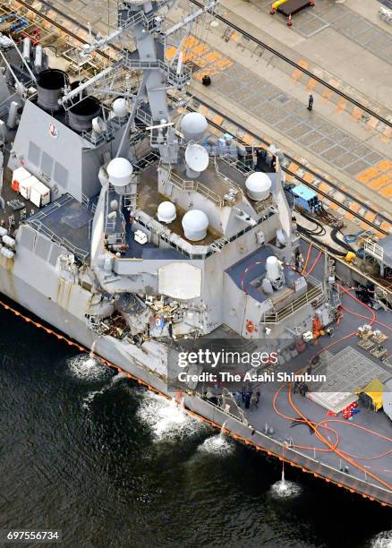 In this aerial image, the USS Fitzgerald, which suffered severe damage on the starboard side, is anchored at the U.S. Naval base on June 18, 2017 in...