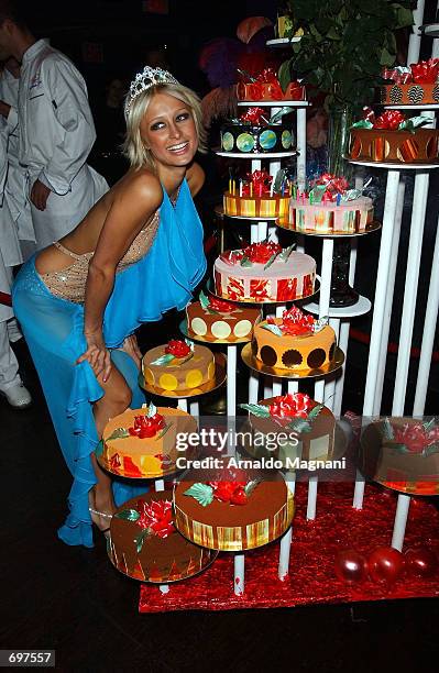 Socialite and hotel heiress Paris Hilton smiles after blowing out candles at her 21st birthday party at Studio 54 February 13, 2002 in New York City.