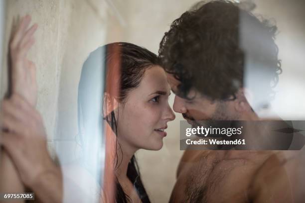 intimate young couple in shower - vorspiel stock-fotos und bilder