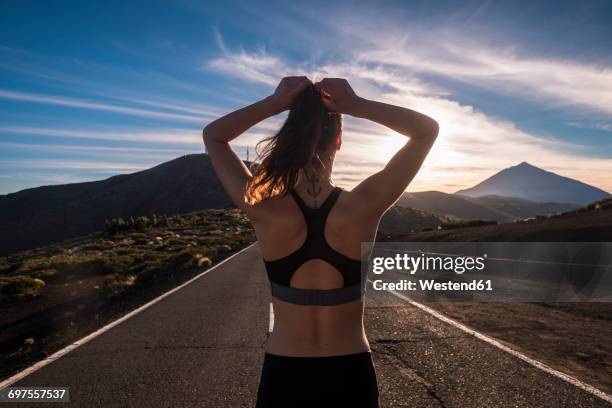 young woman training on empty street - forward athlete stockfoto's en -beelden