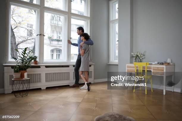 couple looking together through window at home - table side view stock pictures, royalty-free photos & images