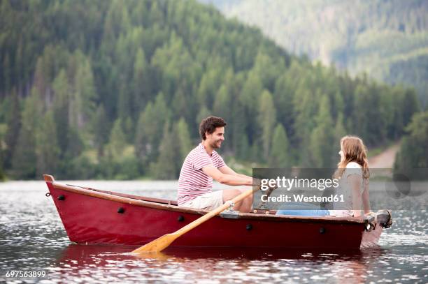 young couple in rowing boat on the lake - 手漕ぎ船 ストックフォトと画像