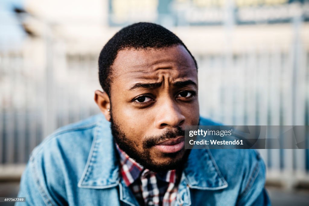 Portrait of sceptical young man