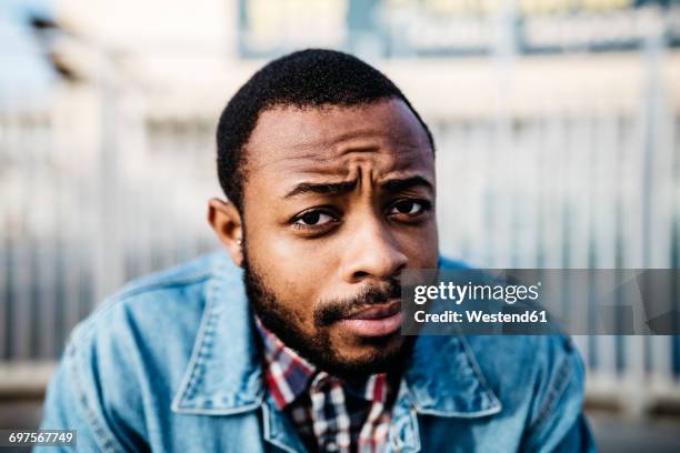 portrait of sceptical young man - asked stock pictures, royalty-free photos & images