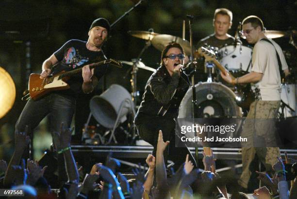 Music group U2 performs during halftime of Super Bowl XXXVI February 3, 2002 at the Superdome in New Orleans, LA. Super Bowl XXXVI is being played by...