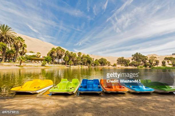 peru, province ica, huacachina, pedalboats at oasis - huacachina stock pictures, royalty-free photos & images