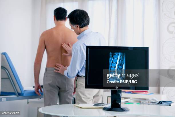 rheumatology consultation man - bandscheibenvorfall stock-fotos und bilder