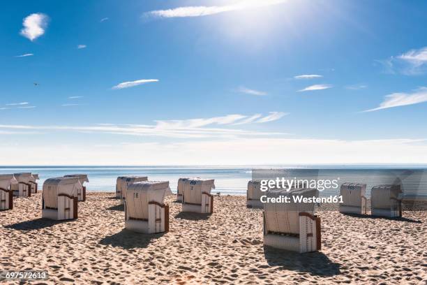 germany, schleswig-holstein, bay of luebeck, hooded beach chairs on the beach - strandkorb stock-fotos und bilder