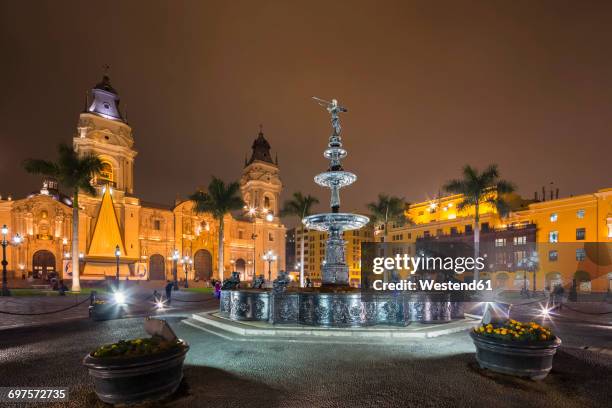 peru, lima, plaza de armas, cathedral of lima and fountain at night - lima region stock pictures, royalty-free photos & images