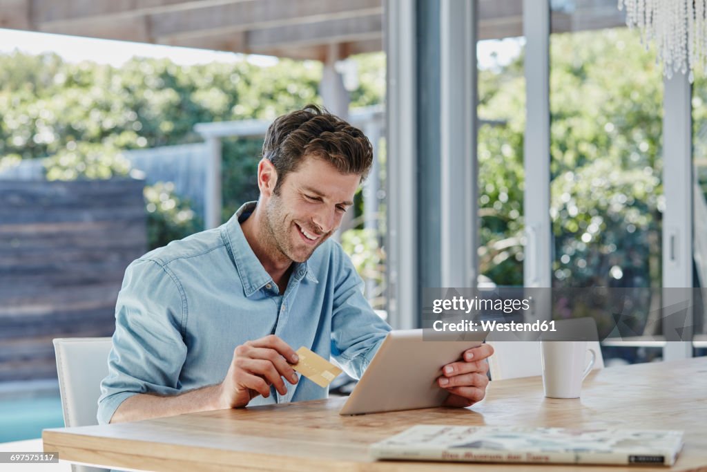 Man doing online payment from digital tablet with credit card
