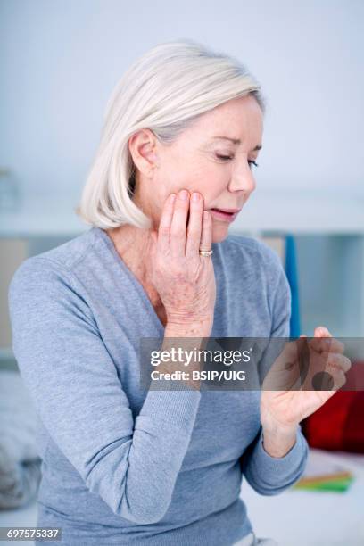 elderly person with a toothache - bruxism stock pictures, royalty-free photos & images