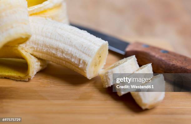 sliced banana on wood - rind stock pictures, royalty-free photos & images