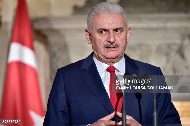 Turkish Prime Minister Binali Yildirim gives a press statement following his meeting with the Greek Prime Minister in Athens on June 19, 2017....