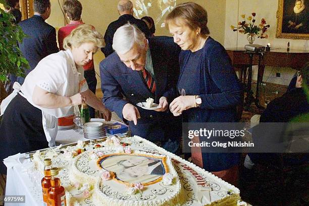 Guests at the Dutch embassy in Moscow eat cake bearing the likeness of Dutch Crown Prince Willem Alexander and bride Crown Princess Maxima...