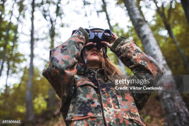 woman patrol with binocular - spy hunter stock pictures, royalty-free photos & images