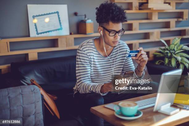 junger mann arbeitet im home office - hipster coffee shop candid stock-fotos und bilder
