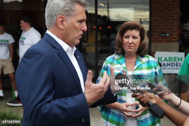 House Majority Leader Rep. Kevin McCarthy speaks with the media as Republican candidate Karen Handel listens during a campaign stop as she runs for...