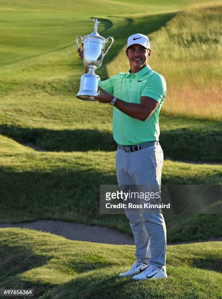 Brooks Koepka of the USA celebrates with the champions trophy after the final round of the 2017 U.S. Open at Erin Hills golf club in Hartford,...