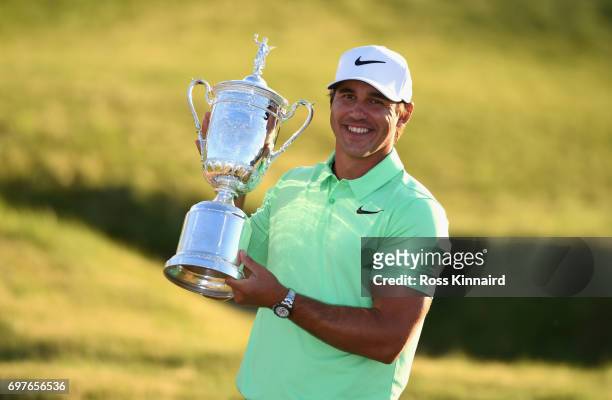 Brooks Koepka of the USA celebrates with the champions trophy after the final round of the 2017 U.S. Open at Erin Hills golf club in Hartford,...
