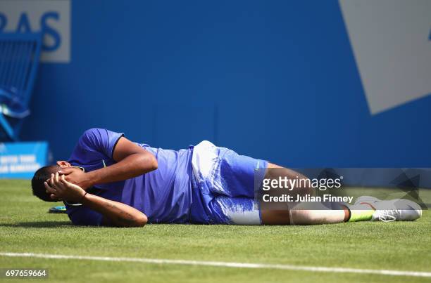 Nick Kygrios of Australia reacts to an injury during the mens singles first round match against Donald Young of The United States during day one of...