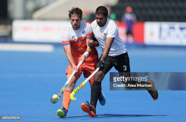 Mirco Pruijser of the Netherlands and Brandon Pereira of Canada battle for possesion during the Hero Hockey World League Semi-Final match between...