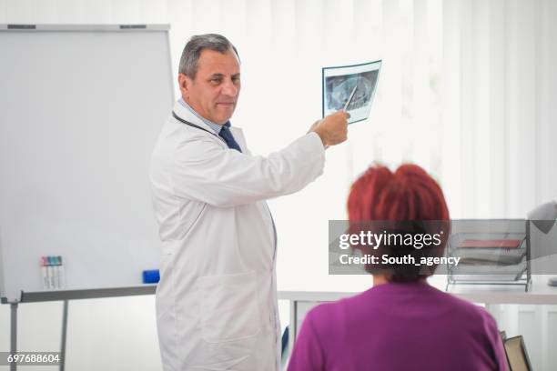 showing her x-ray image - ordination stock pictures, royalty-free photos & images
