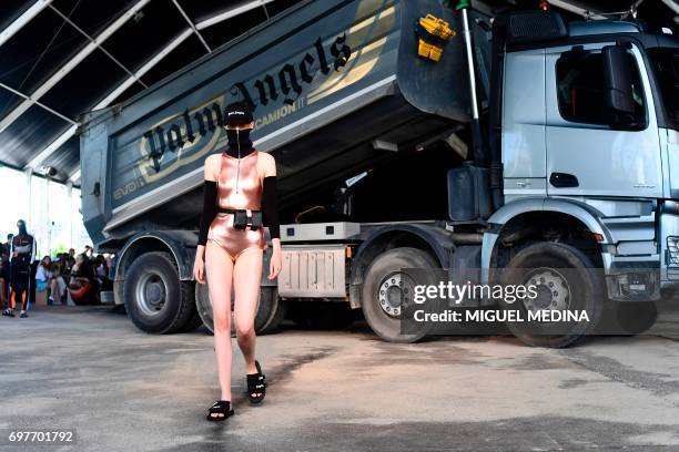 Model presents a creation for fashion house Palm Angels during the Men's Spring/Summer 2018 fashion shows in Milan, on June 19, 2017. / AFP PHOTO /...