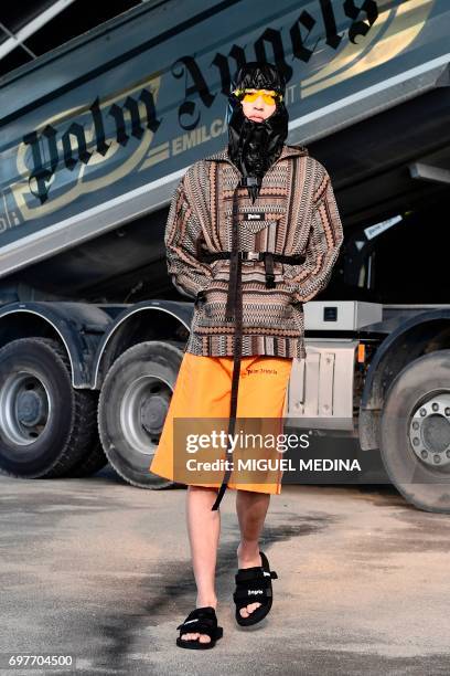 Model presents a creation for fashion house Palm Angels during the Men's Spring/Summer 2018 fashion shows in Milan, on June 19, 2017. / AFP PHOTO /...