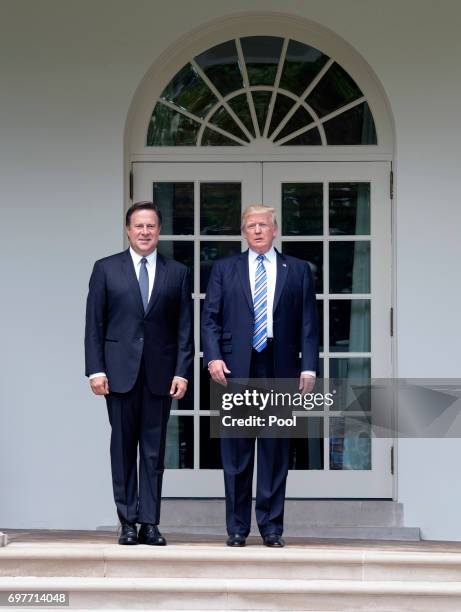 President Donald Trump poses with Panama's President Juan Carlos Varela before they walk to the Oval Office for their meeting at the White House on...