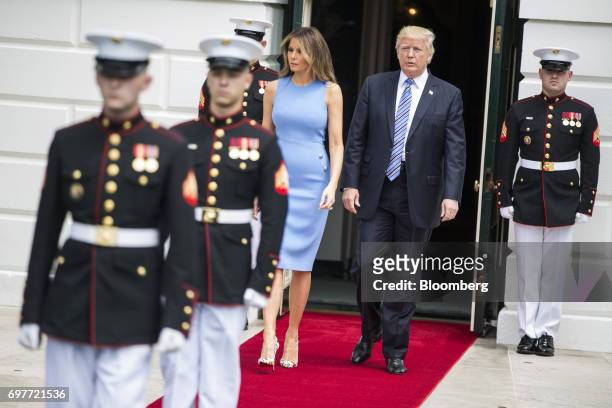 President Donald Trump, right, and First Lady Melania Trump walk out of the South Portico of the White House to greet Juan Carlos Varela, Panama's...