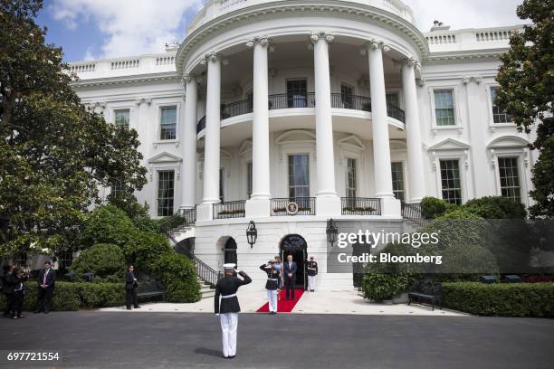 President Donald Trump, right, and U.S. First Lady Melania Trump walk out of the South Portico of the White House to greet Juan Carlos Varela,...