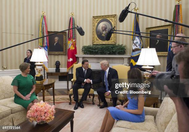 President Donald Trump, second right, shakes hands with Juan Carlos Varela, Panama's president, second left, as First Lady Melania Trump, right, and...