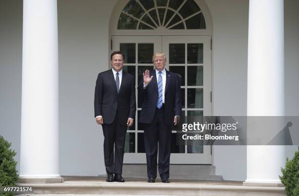 President Donald Trump waves to members of the media will standing for photographs with Juan Carlos Varela, Panama's president, left, near the Oval...
