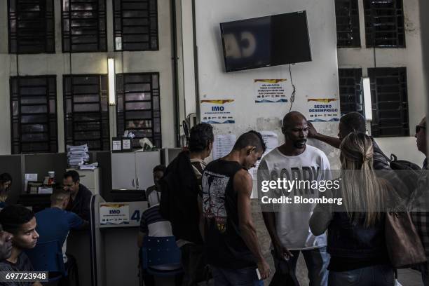 Job seekers view job announcements displayed inside the Ministry of Labor and Employment building in Rio de Janeiro, Brazil, on Monday, June 19,...